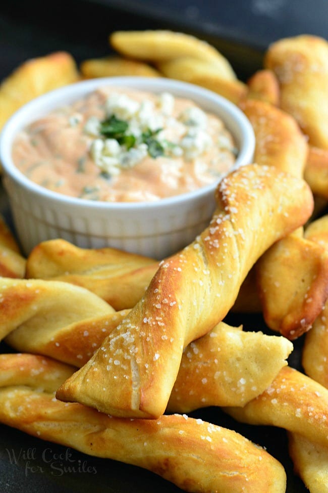 Homemade Soft Pretzel Twists with Creamy Buffalo Sauce. Amazing snack to serve at your Super Bowl party and every other party! Homemade soft, salted pretzels served with delicious creamy buffalo sauce. | from willcookforsmiles.com
