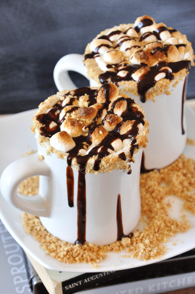 Mugs of our delicious S'mores Hot Chocolate recipe dripping with chocolate sauce