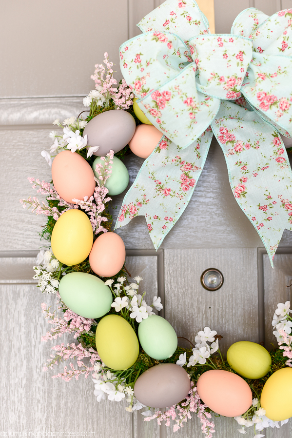 Easter Egg Wreath - create a beautiful Spring wreath with easter eggs, moss, and flowers. Add a pink and mint floral bow and you have a pretty DIY Easter egg wreath to welcome guests.